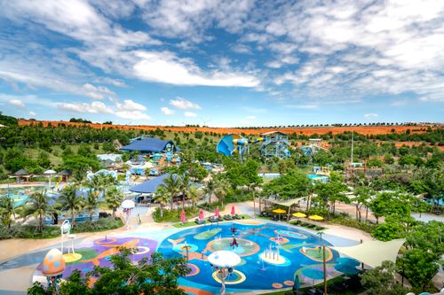 Free A colorful water park with slides and trees on a sunny day, perfect for family fun. Stock Photo
