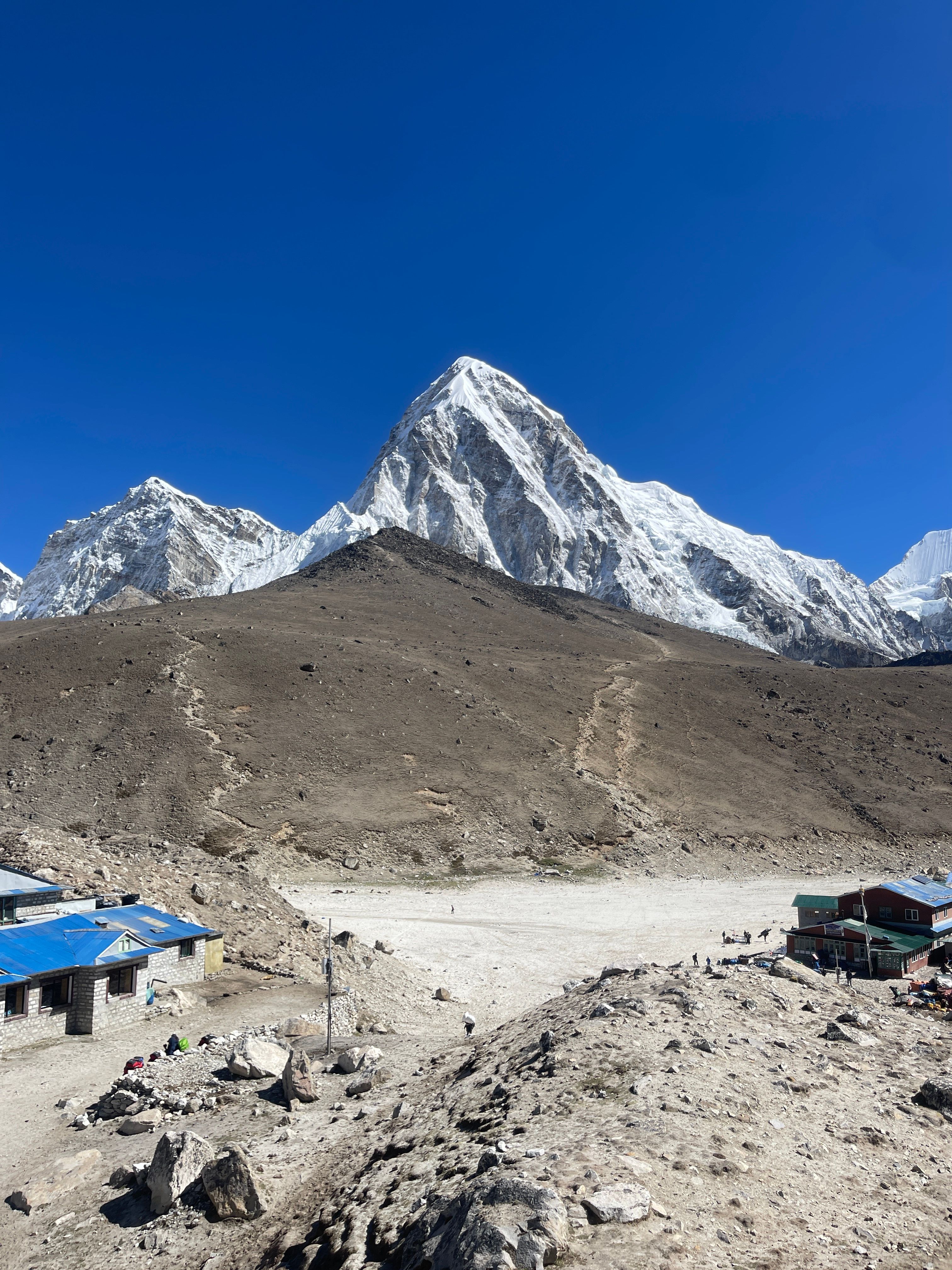 Pumori rising above the brown hump of Kala Patthar at Gorak Shep