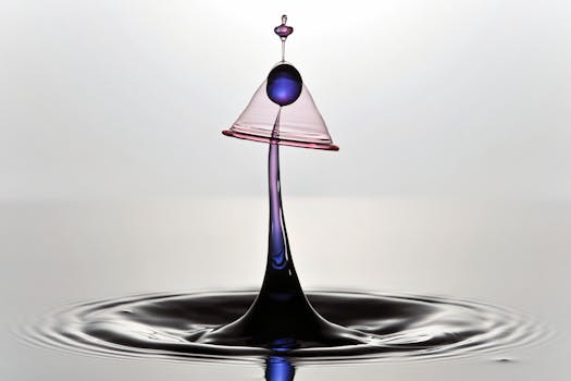 Intricate macro capture of a dynamic water droplet collision with vibrant colors, highlighting fluid motion.