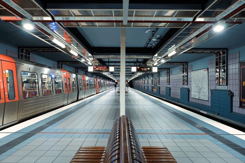 A quiet and modern subway station in Hamburg, showcasing sleek architecture and trains.