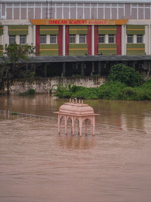 Free A flooded scene in Varanasi featuring a submerged pavilion and Sunbeam Academy building. Stock Photo