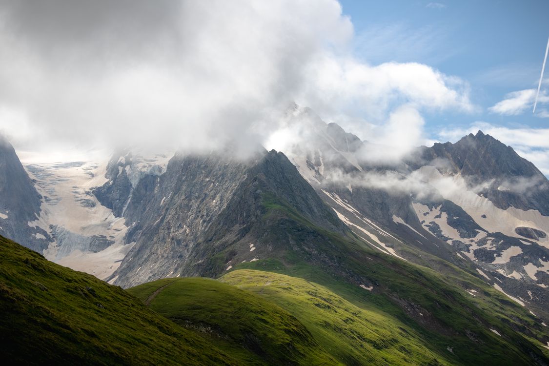 Majestic Tirol Mountain Landscape Under Cloudy Skies · Free Stock Photo