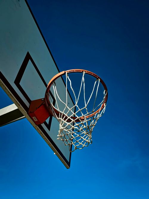 Free A basketball hoop silhouetted against a clear blue sky in Karlsruhe, Germany. Stock Photo