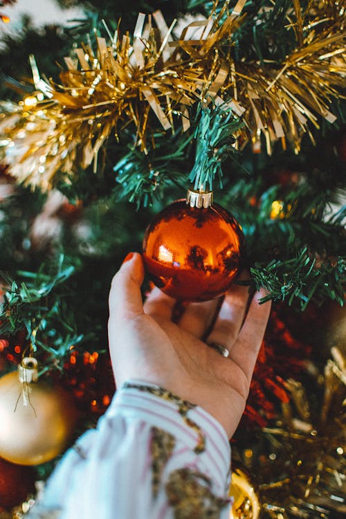 Photo Of Person Touching Christmas Ball