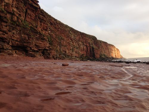 Free Scenic view of the red sandstone cliffs and sandy beach at St Bees, England. Stock Photo