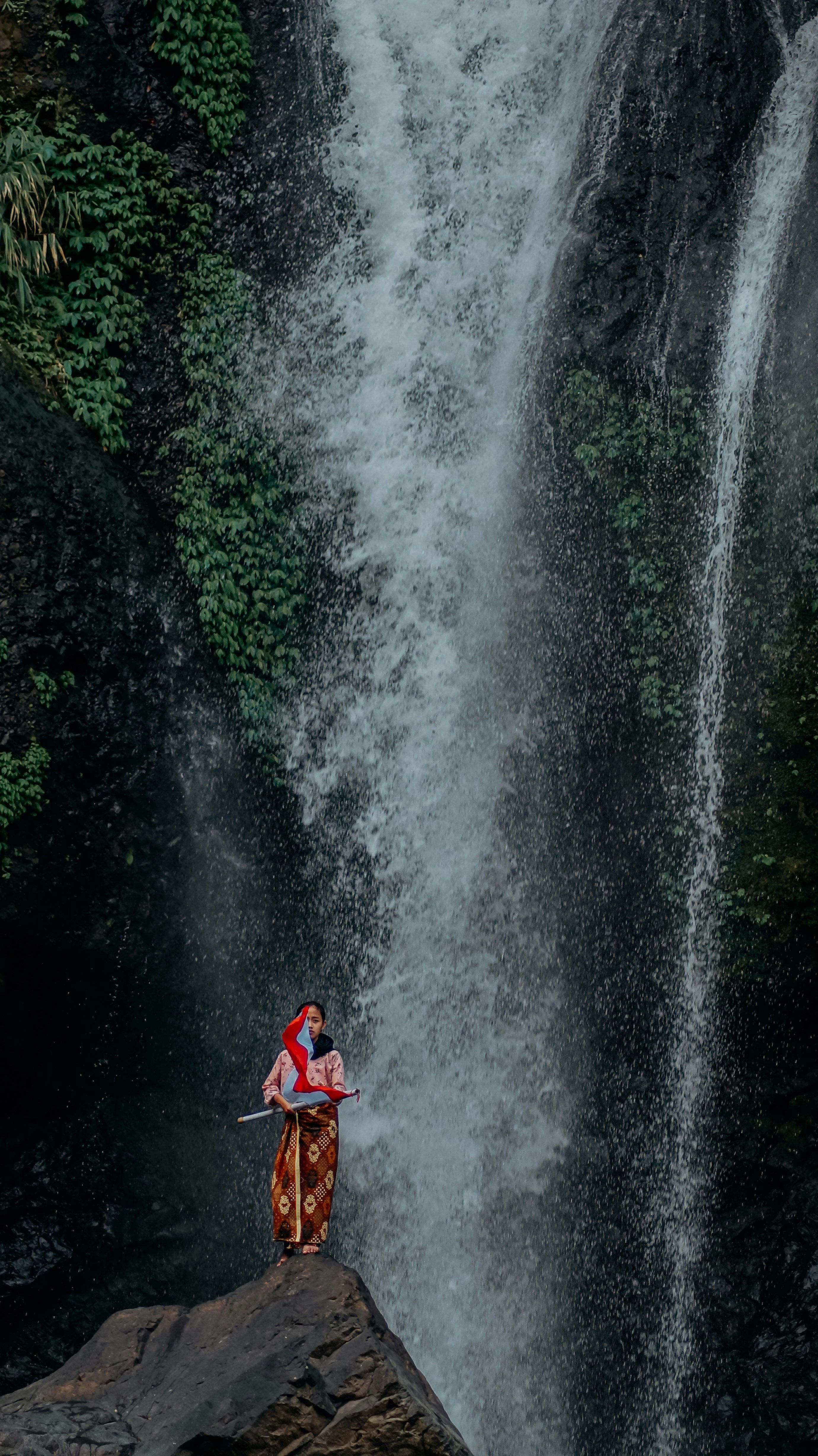 Traditional Attire by Indonesian Waterfall