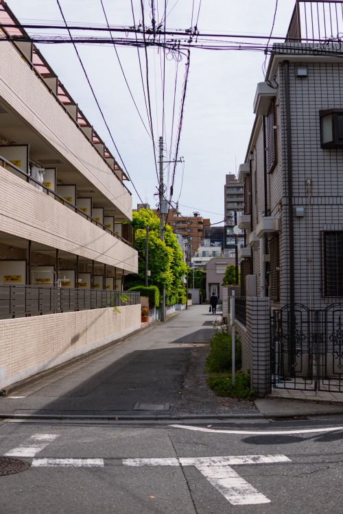 Free Tranquil urban street in a Japanese residential neighborhood under clear skies. Stock Photo