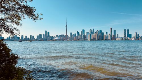 Free Beautiful view of Toronto skyline with CN Tower from across the water on a clear day. Stock Photo