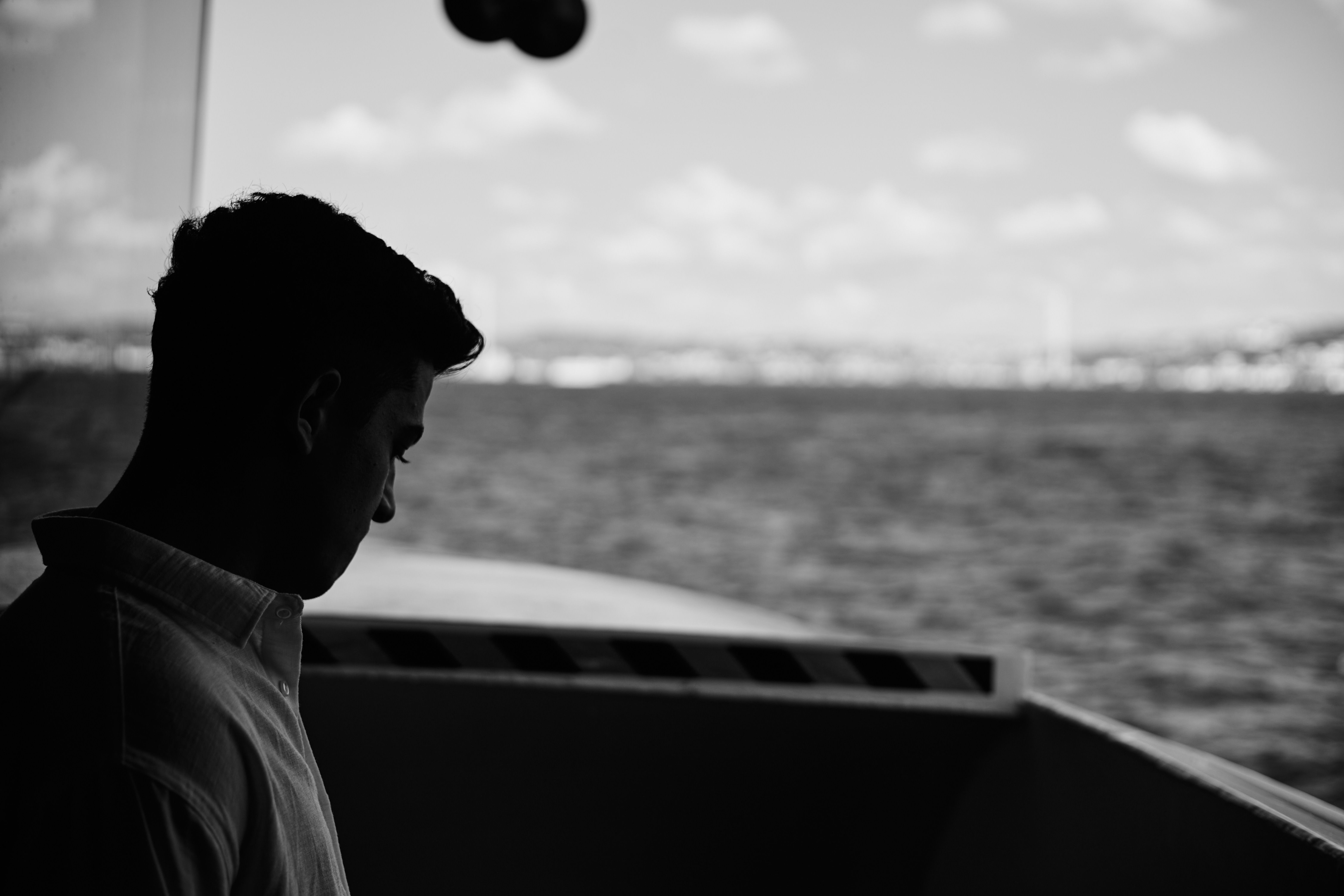 Silhouette of Contemplative Man by the Sea · Free Stock Photo