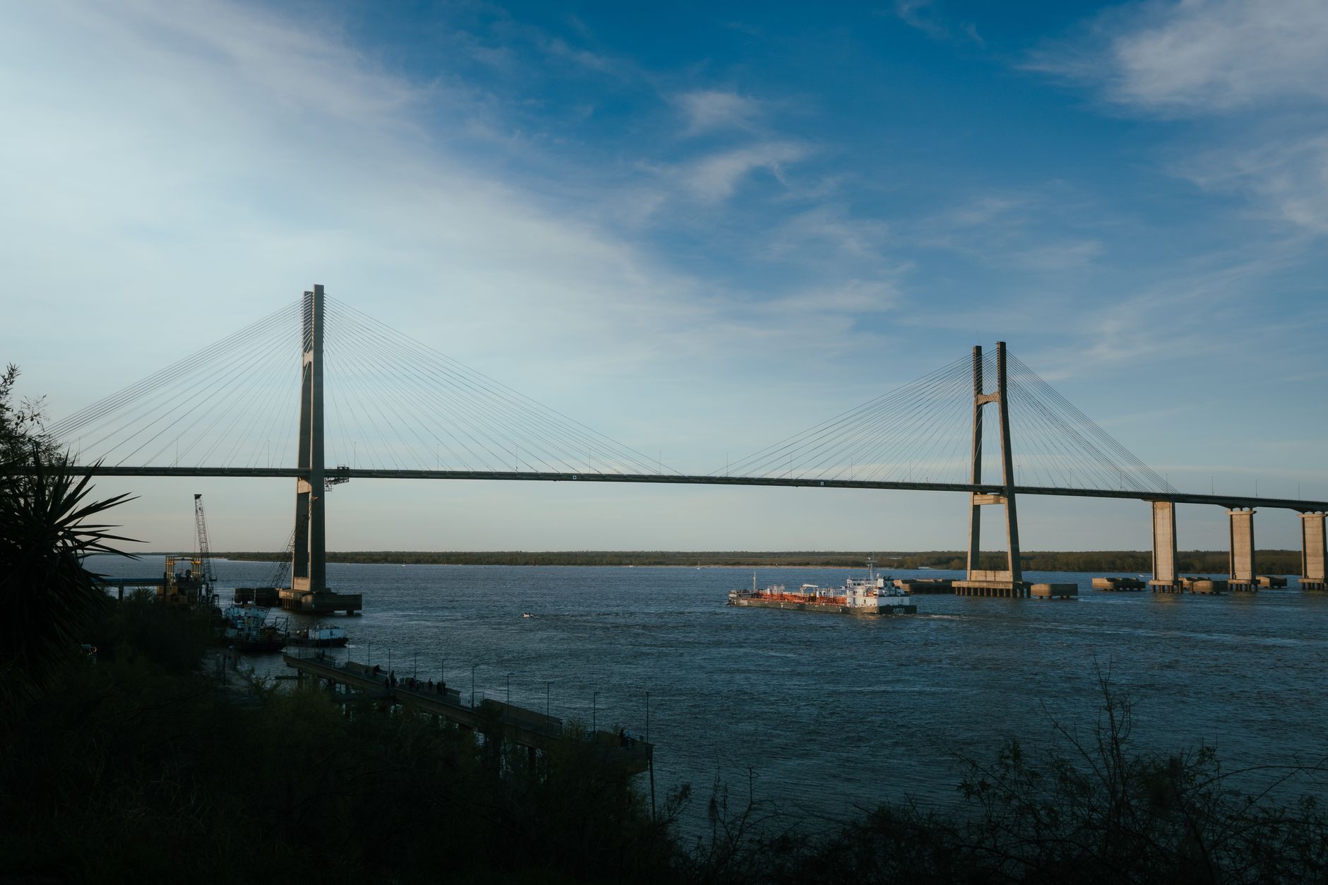 Scenic view of the Rosario-Victoria Bridge spanning the Paraná River in Argentina during sunset.