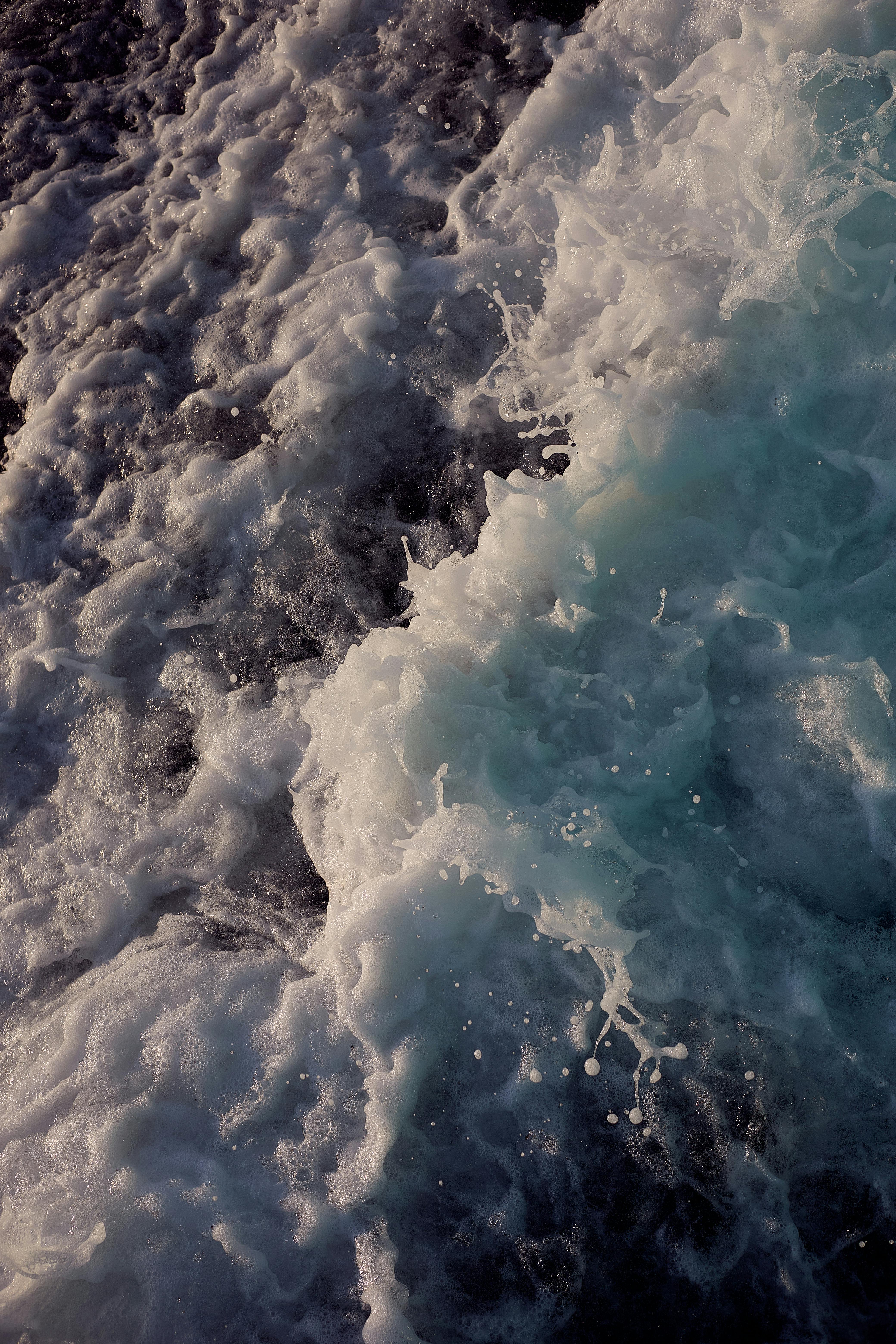 Close-up of ocean waves showing dynamic movement and contrasting colors.