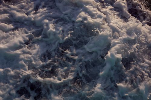Free Aerial view of turbulent ocean waves with foamy texture and movement. Stock Photo