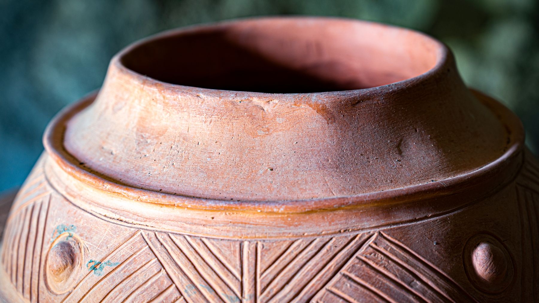 Close-up of a textured, hand-finished terracotta pot rim