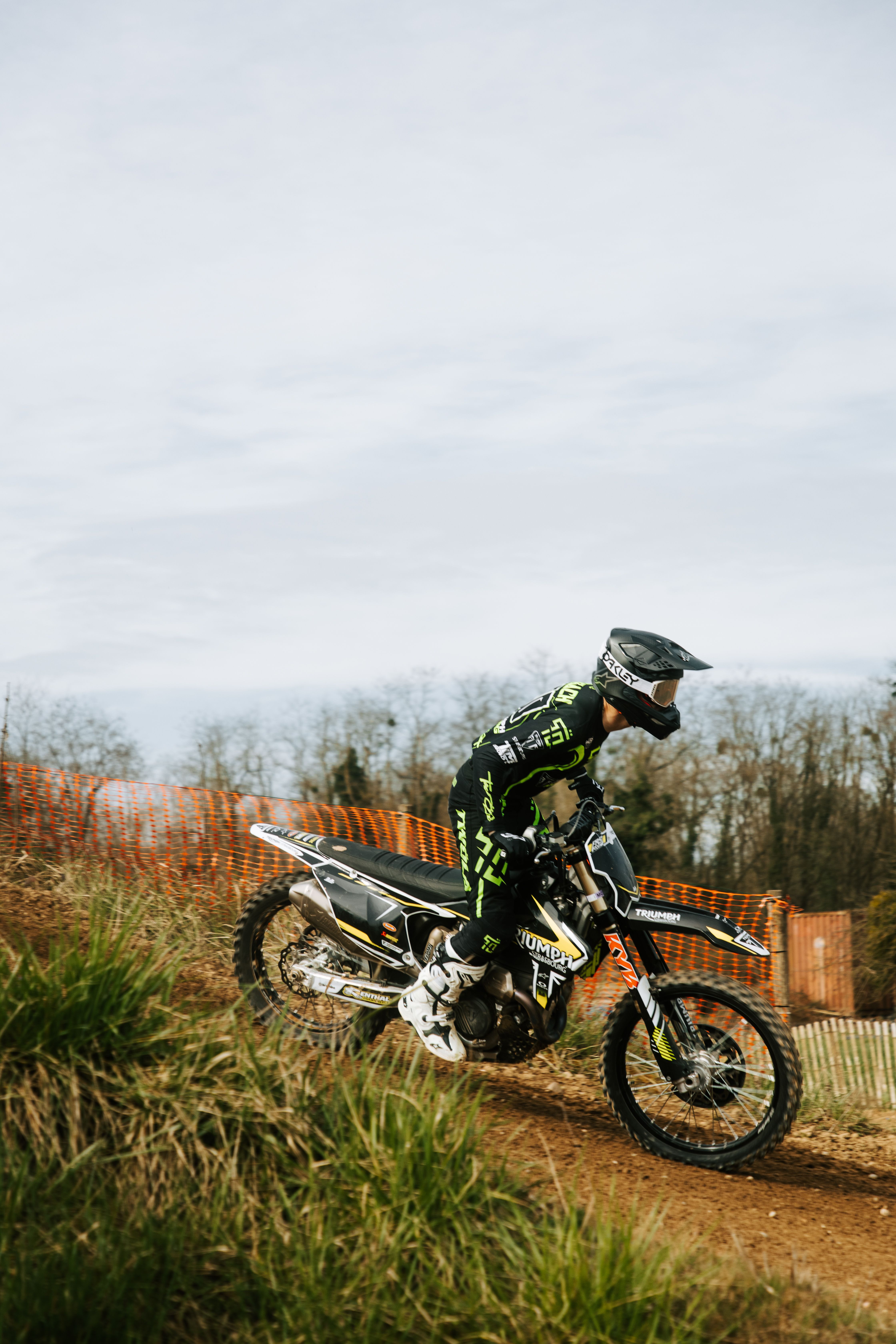 Dynamic image of a motocross rider racing on a dirt track in Germany, showcasing thrilling sports action.