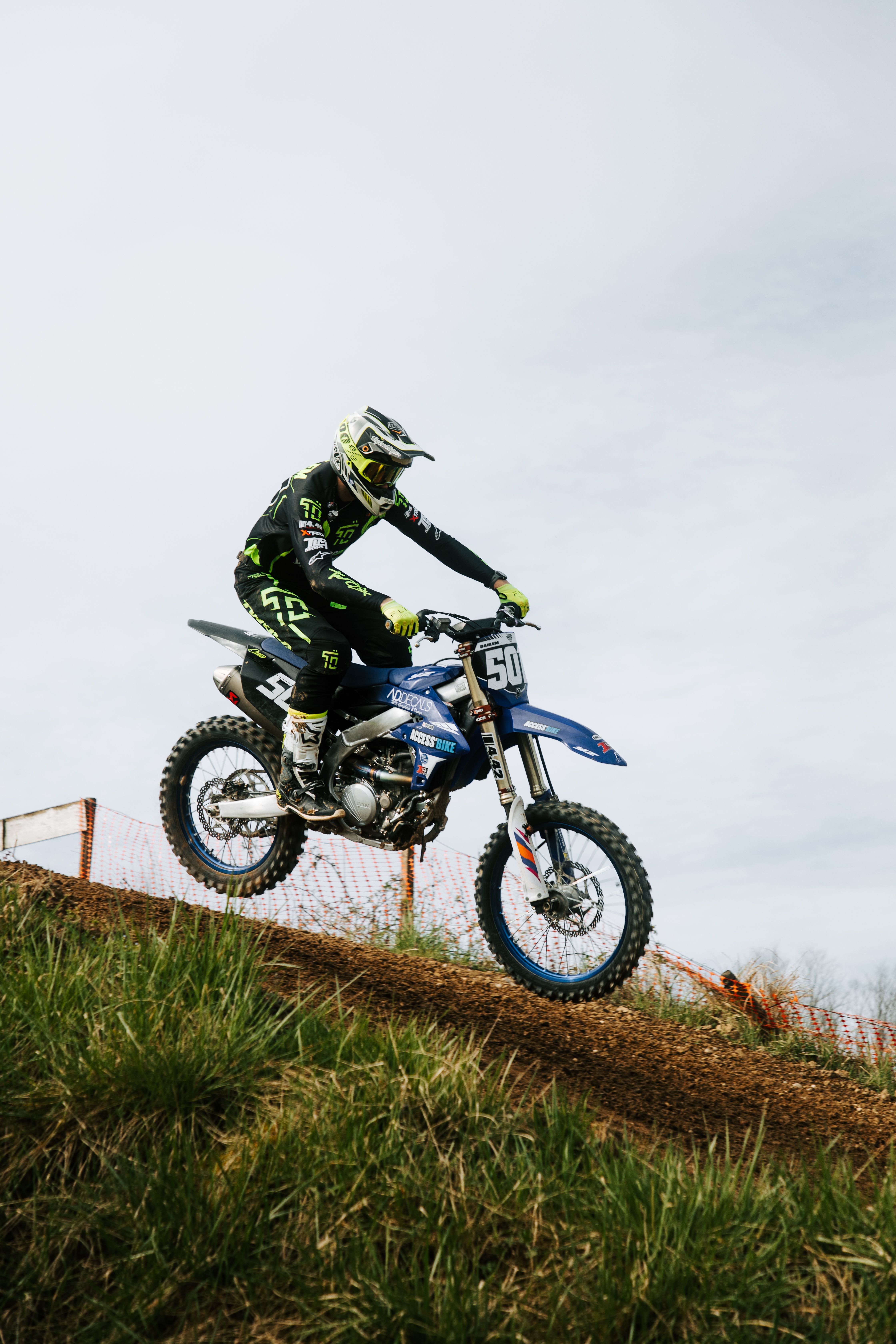 Dynamic Motocross Rider in Action on Dirt Track · Free Stock Photo