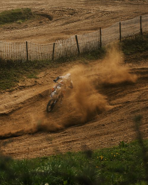 Free Thrilling motocross competition capturing action on a dirt track in Germany with a rider kicking up dust. Stock Photo