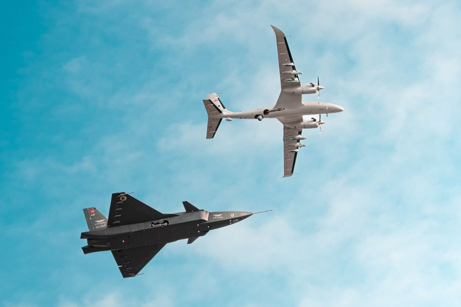 A dynamic view of two fighter jets performing an aerobatic maneuver in a clear blue sky.