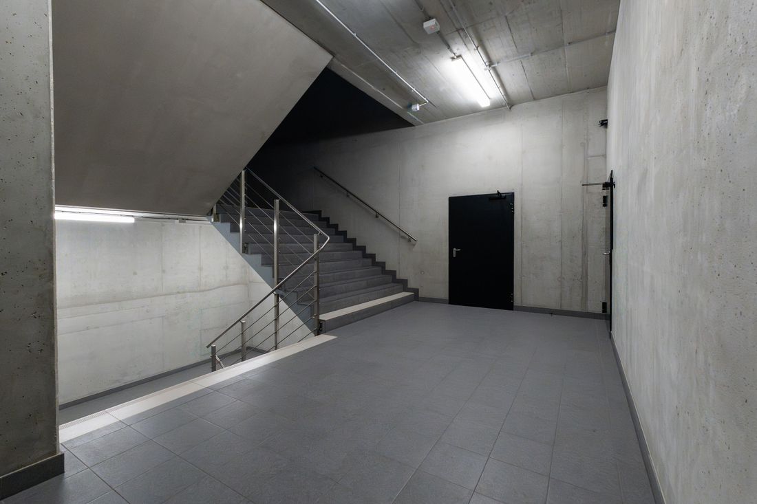 Concrete stairwell in a modern office building — photo by Jakub Zerdzicki on Pexels