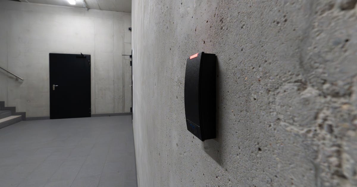 A smart electronic access terminal mounted on a concrete wall in an industrial interior for enhanced security.