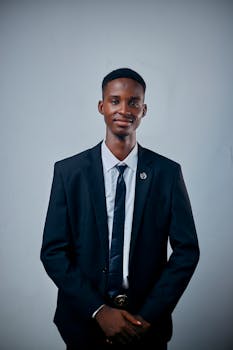 Portrait of a young man dressed in a suit, exuding confidence and professionalism.
