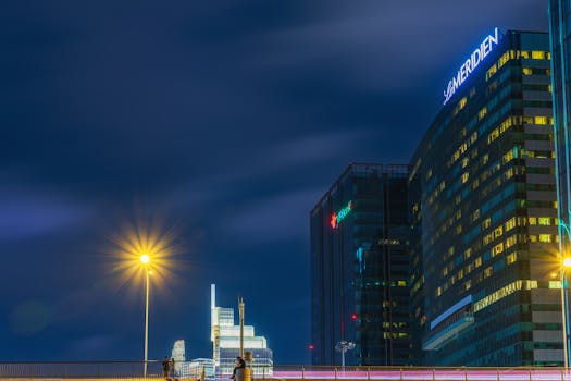 Vibrant night view of modern skyscrapers in Ho Chi Minh City, Vietnam featuring illuminating lights.
