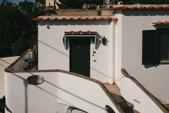 Mediterranean architecture with a curved stucco staircase, reference for two story townhomes