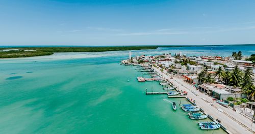 Free A breathtaking aerial shot of a coastal town and marina with turquoise waters on a sunny day. Stock Photo