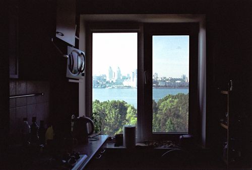 Free Scenic view of Dnipro city skyline and river through a kitchen window, creating a cozy vibe. Stock Photo
