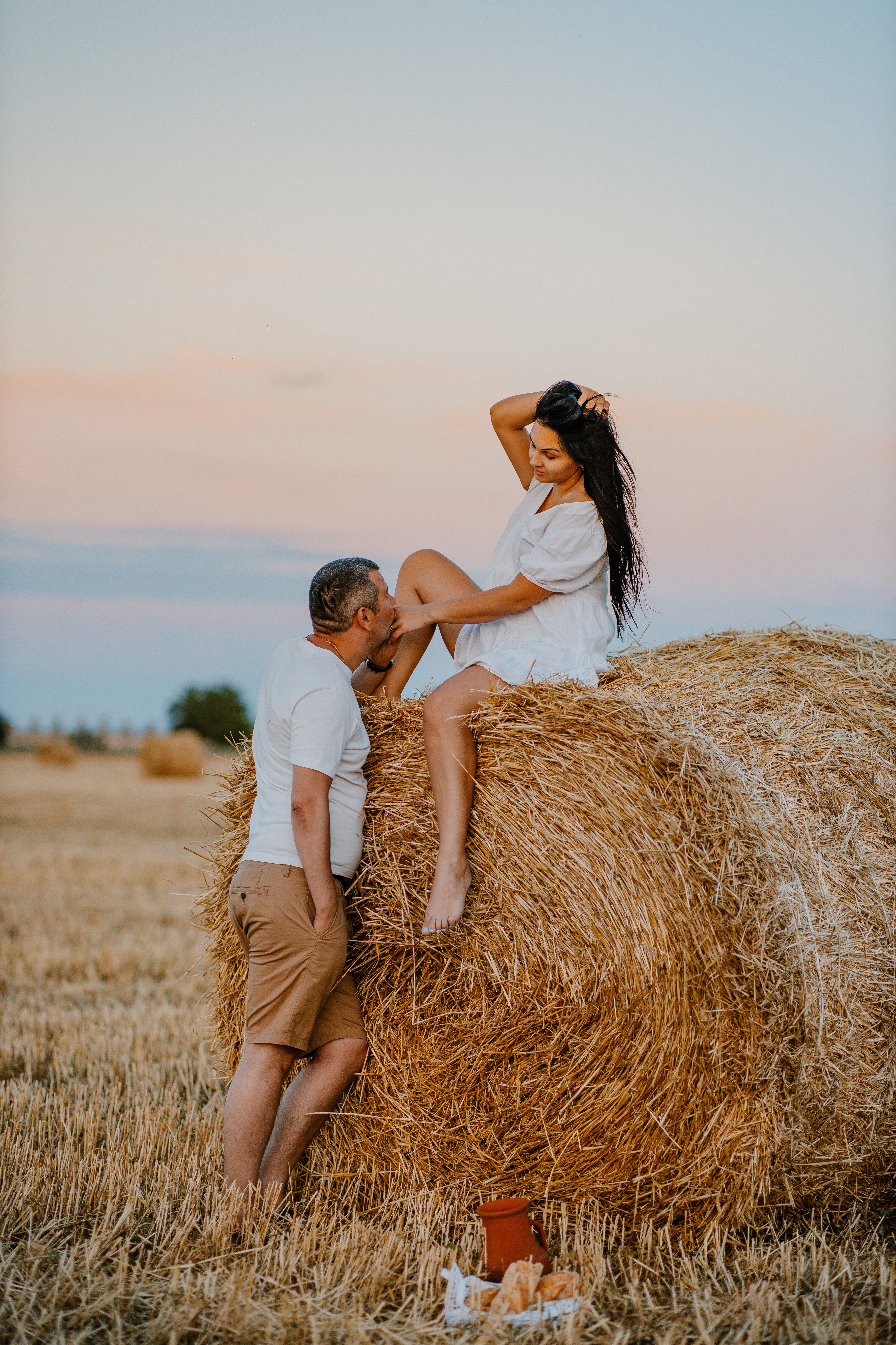 Romantic Couple in Wheat Field at Sunset · Free Stock Photo