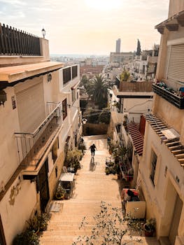 A picturesque street in Alicante, Spain, at golden hour highlighting Mediterranean architecture.