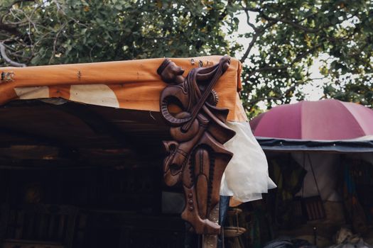 Detailed wooden sculpture displayed outdoors in Federal Capital Territory, Nigeria, highlighting African art and craftsmanship.