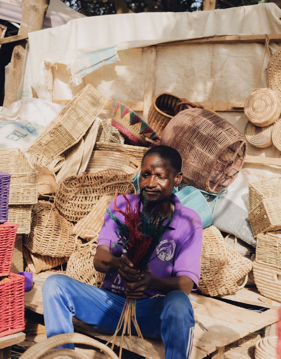 Hand-woven straw baskets and crafts at a market stall.
