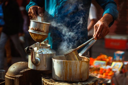 A vendor prepares steaming chai on the busy streets of Varanasi, India.