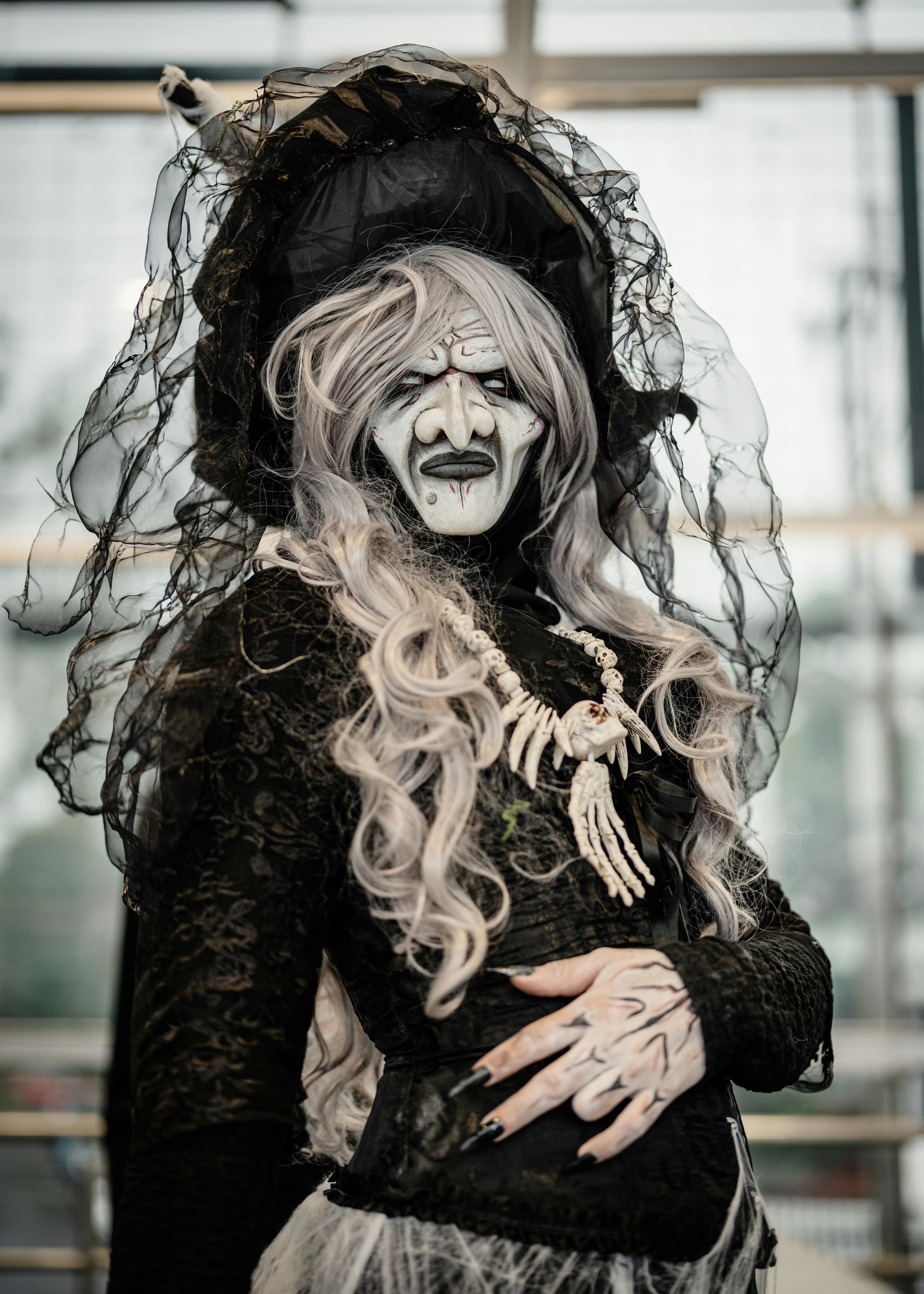 Intricate witch cosplay with gothic style at a San José anime convention.