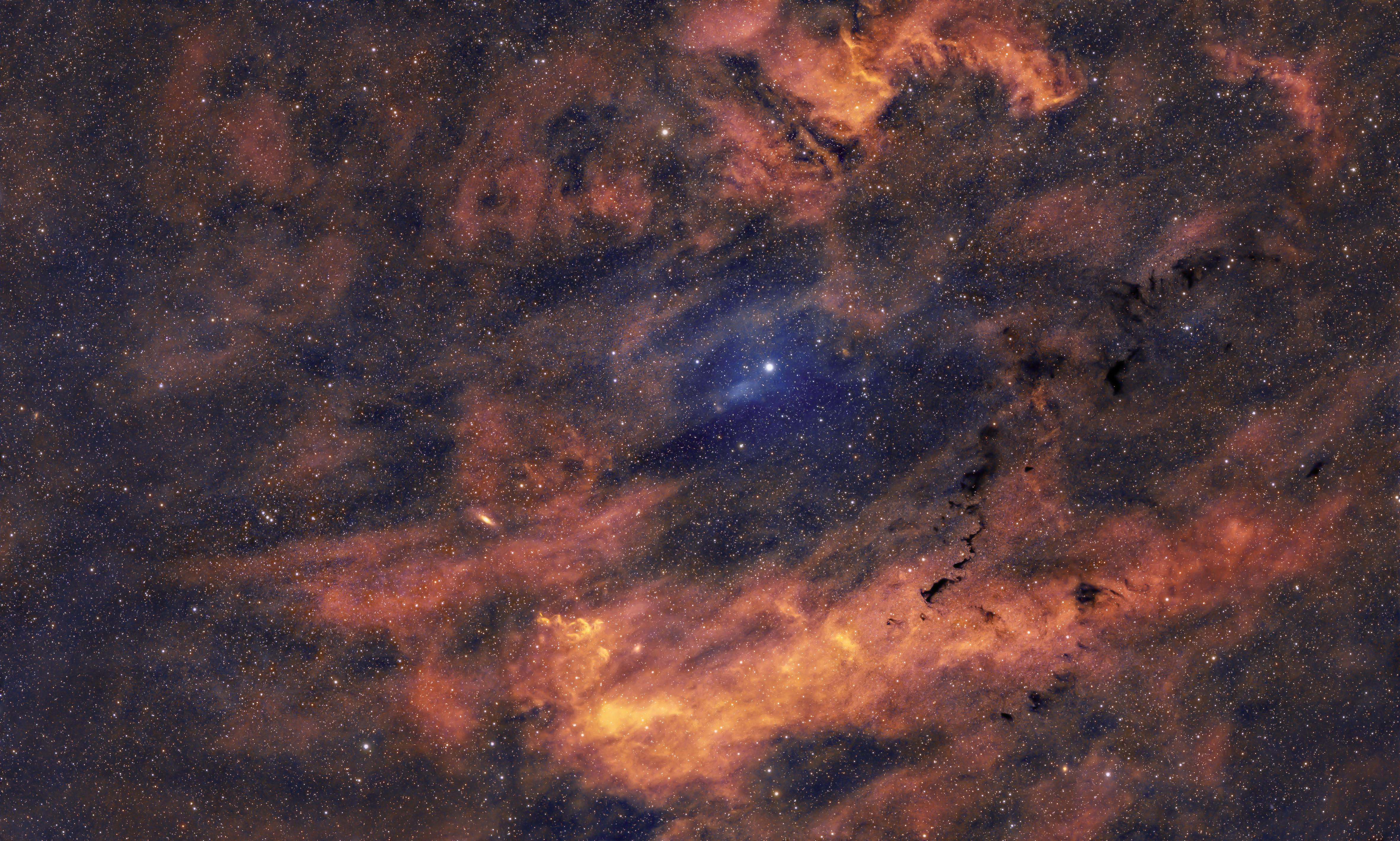 Wide view of a colorful cosmic nebula and stars, creating a mesmerizing celestial scene.