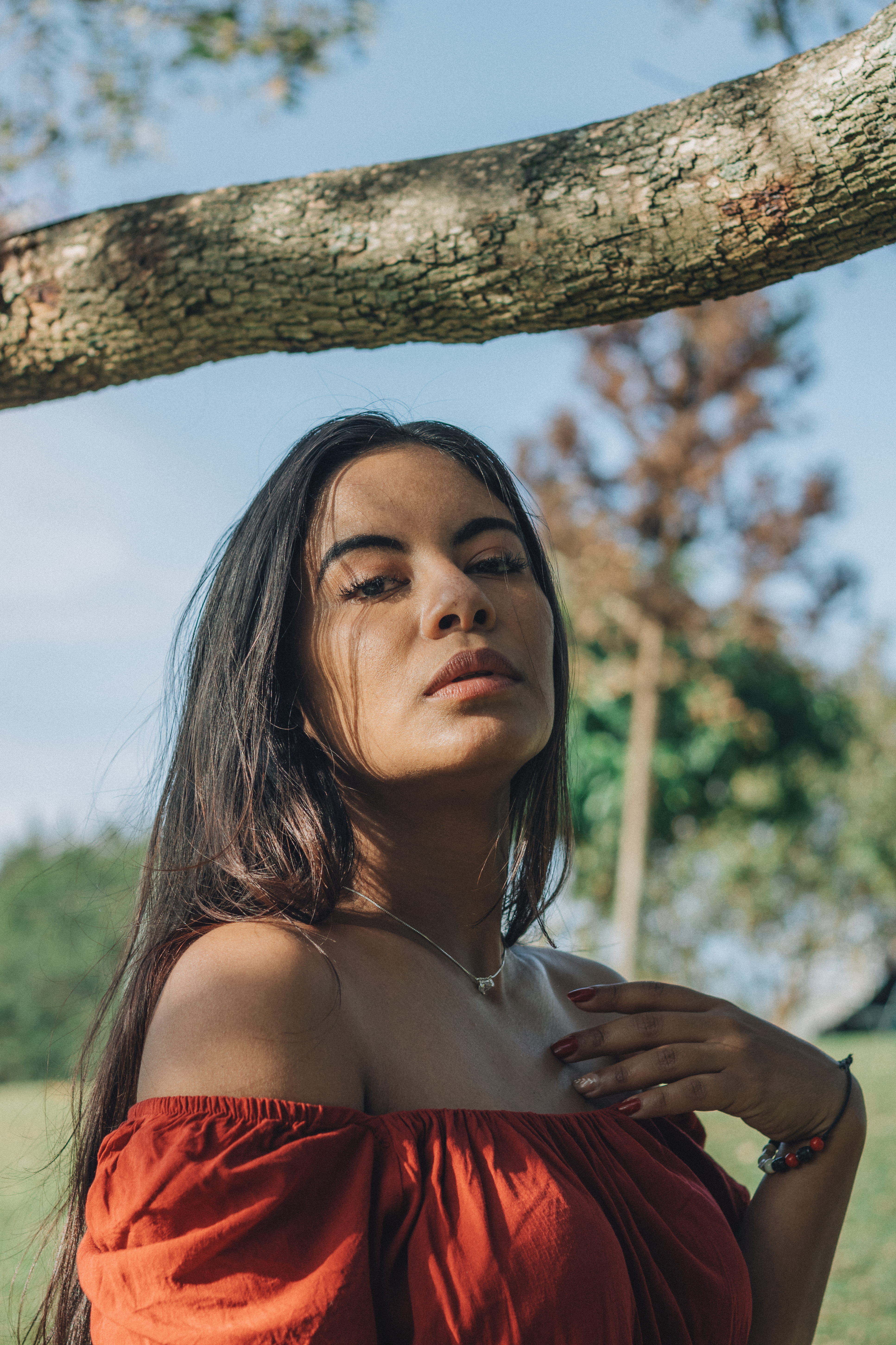 Young Woman in Red Dress Under Tree Outdoors · Free Stock Photo