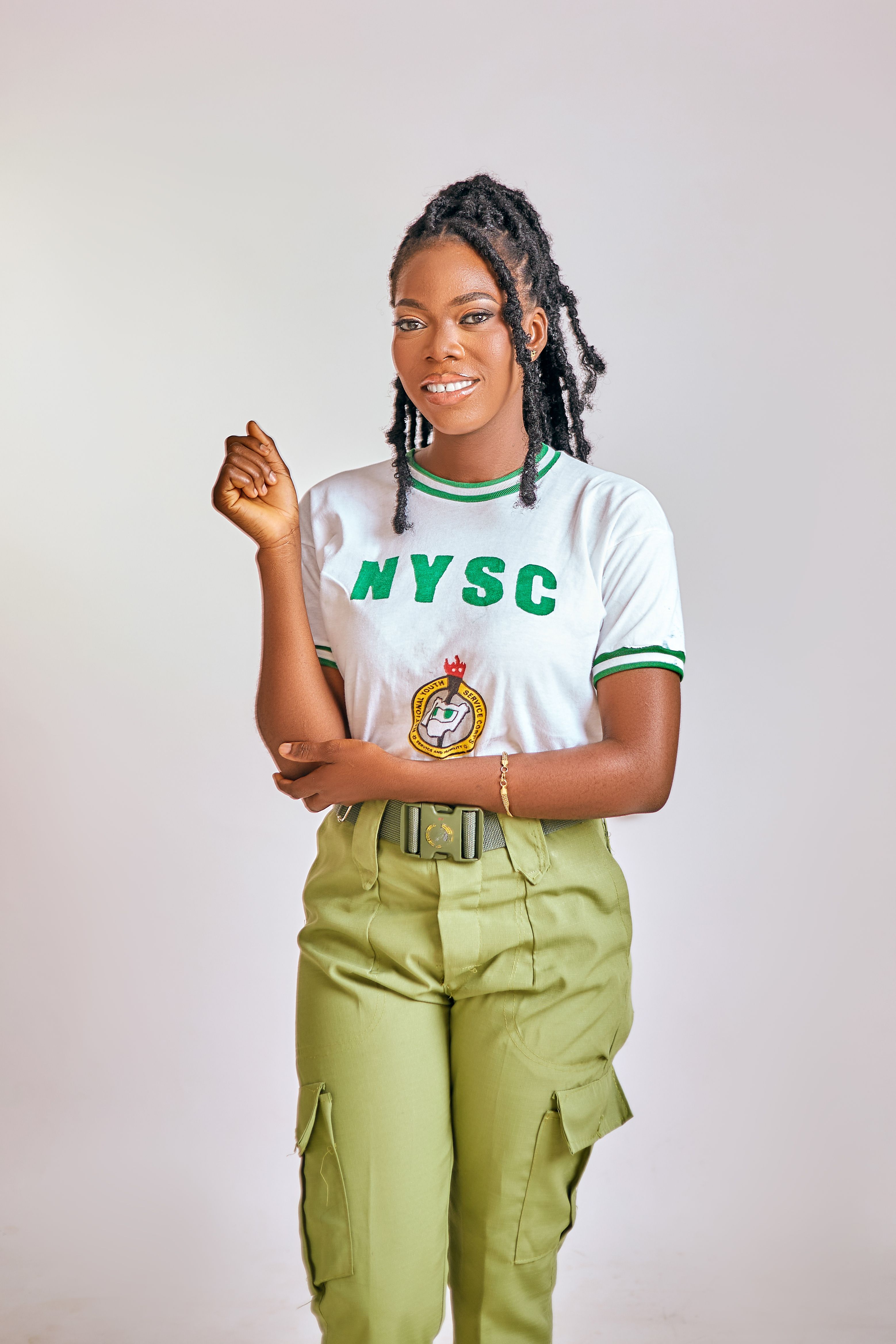 Smiling Young Woman in NYSC Uniform Portrait · Free Stock Photo