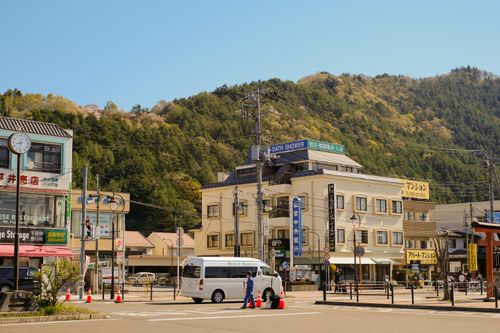 Free A vibrant town square surrounded by buildings and hills under a clear blue sky. Stock Photo