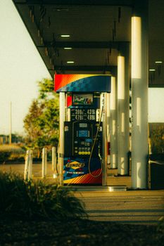A vibrant Sunoco gas station pump captured at sunset with warm lighting and modern design.