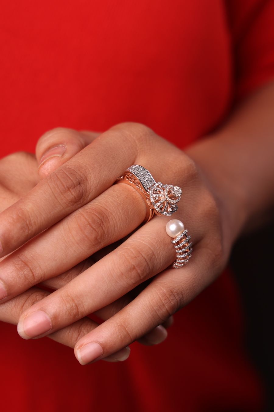 A hand wearing stacked diamond rings
