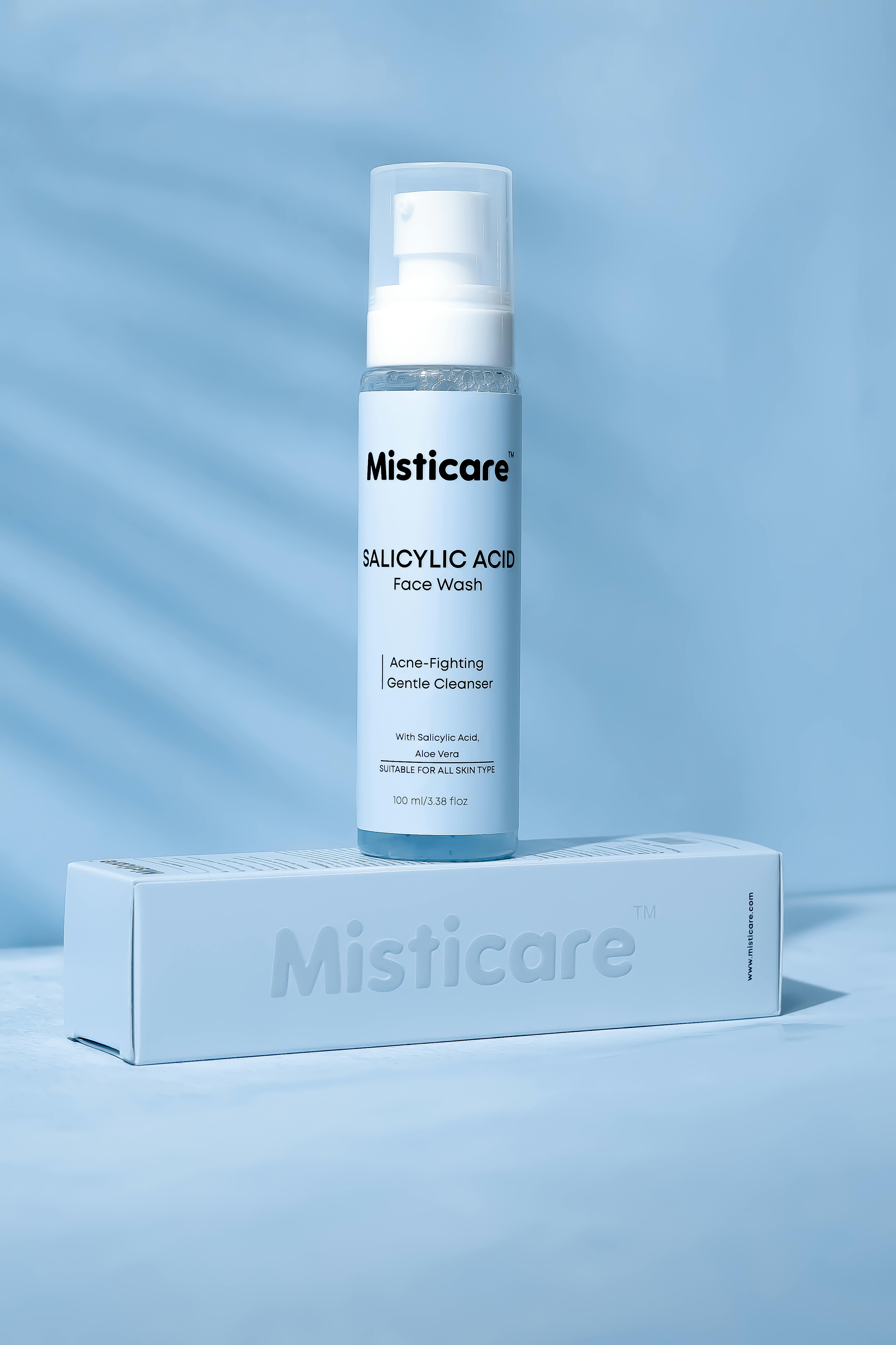 Elegant product shot of Misticare Salicylic Acid Face Wash with packaging on a blue background.