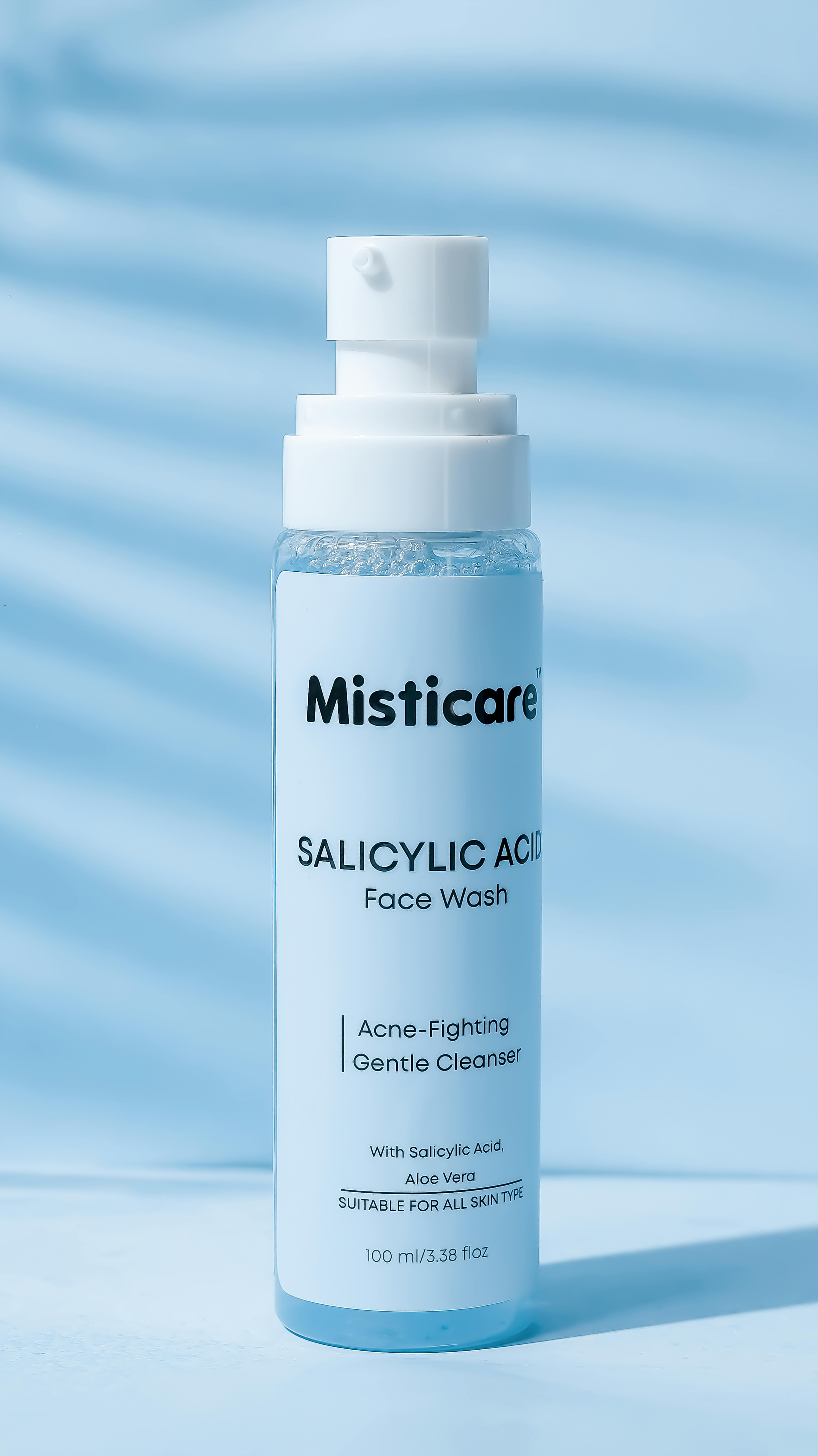 Close-up of Misticare Salicylic Acid Face Wash against blue background.