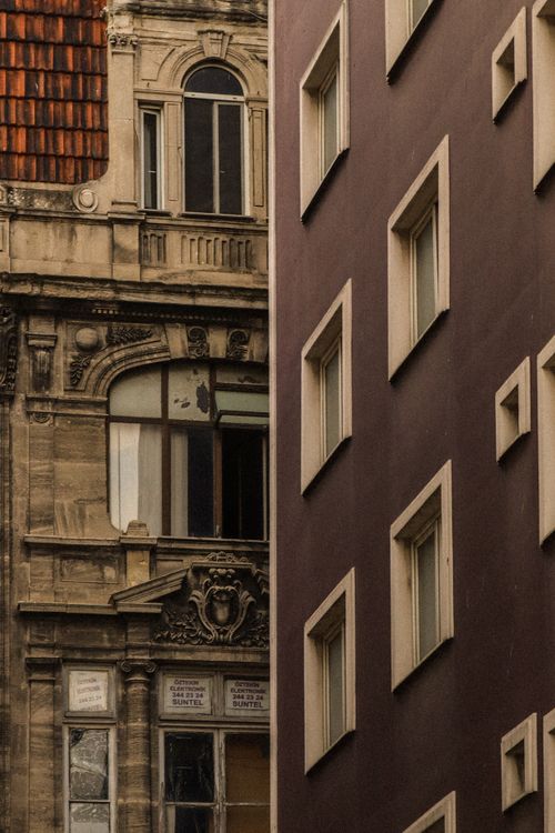 Free Close-up of two contrasting architectural styles in a cityscape. Stock Photo