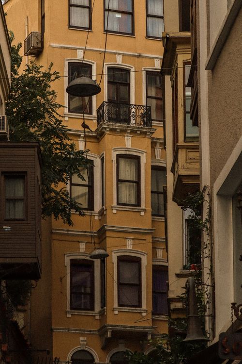 Free A classic European residential building facade with warm hues and intricate details. Stock Photo