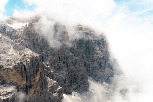 Free Breathtaking view of the misty Dolomites enveloped in clouds, showcasing rugged cliffs and serene nature. Stock Photo