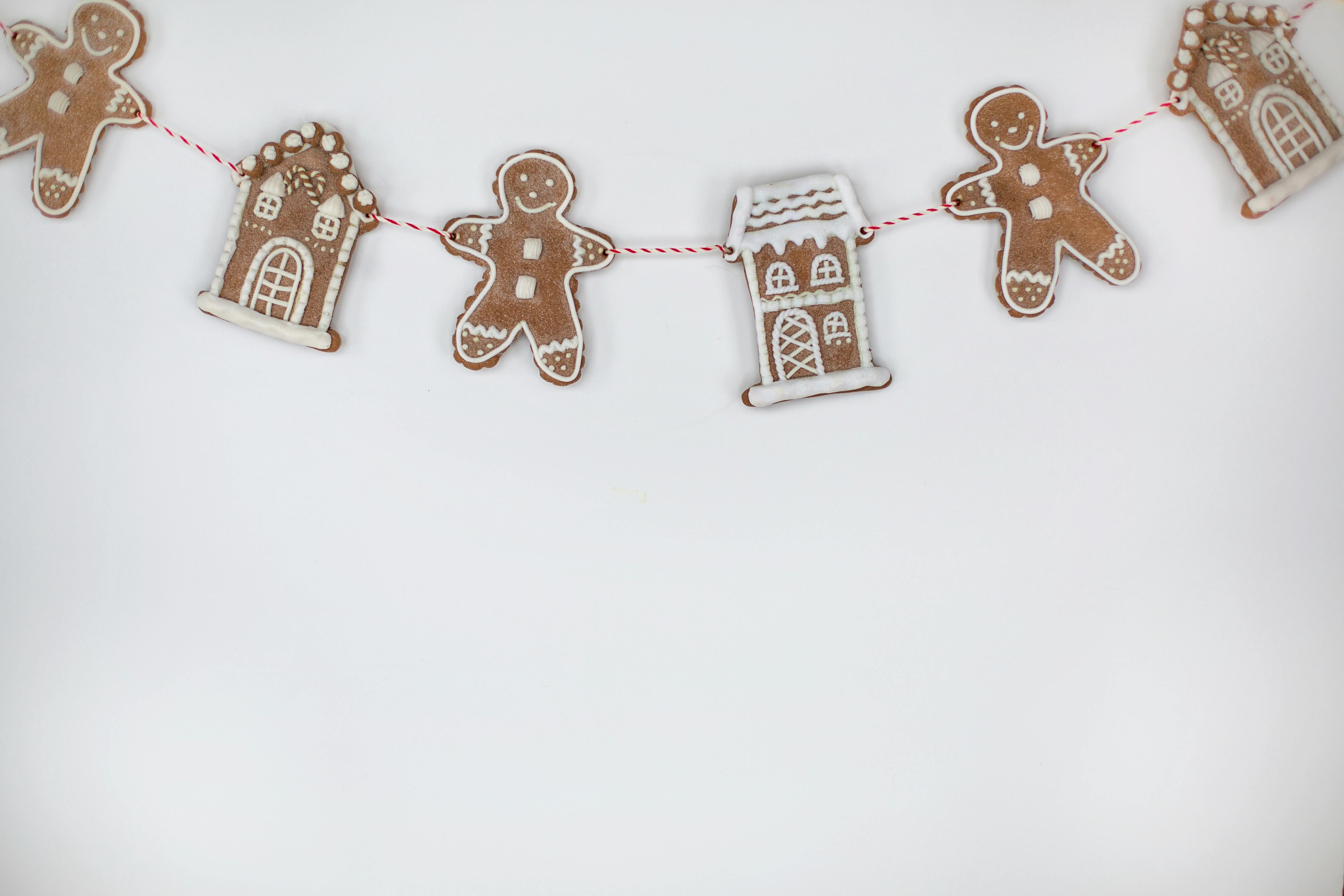 Premium Photo  Christmas gingerbread cookie preparation process with  gingerbread man icing sugar sprinkles and candy canes on a red table  background new year wallpaper flat lay