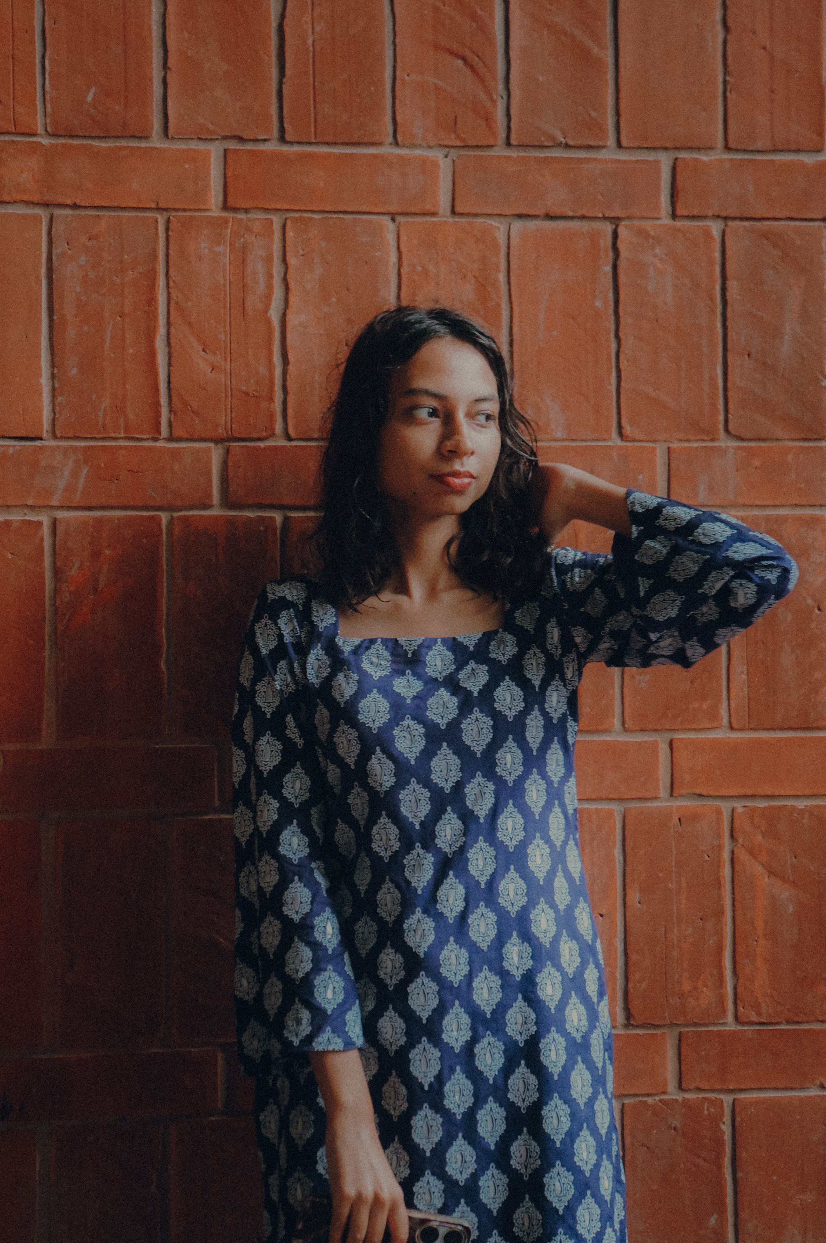 A Woman in a Blue Saree Standing on a Staircase · Free Stock Photo