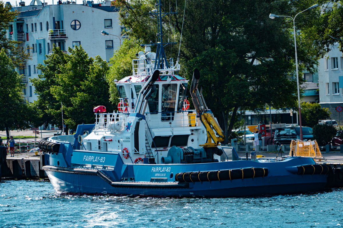 Tugboat stationed at a working harbor
