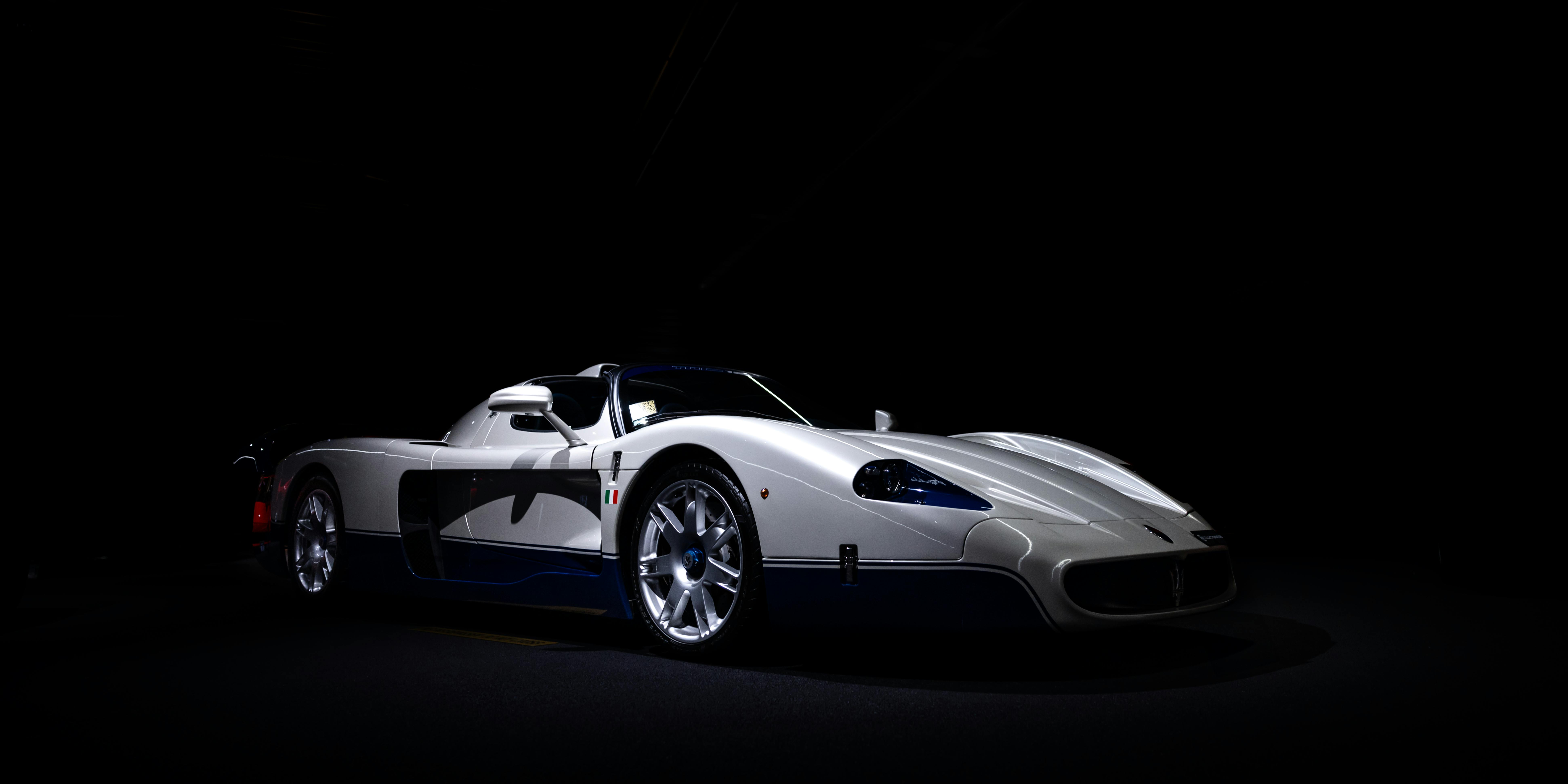 Free A stylish white sports car highlighted against a dark background, emphasizing luxury and speed. Stock Photo