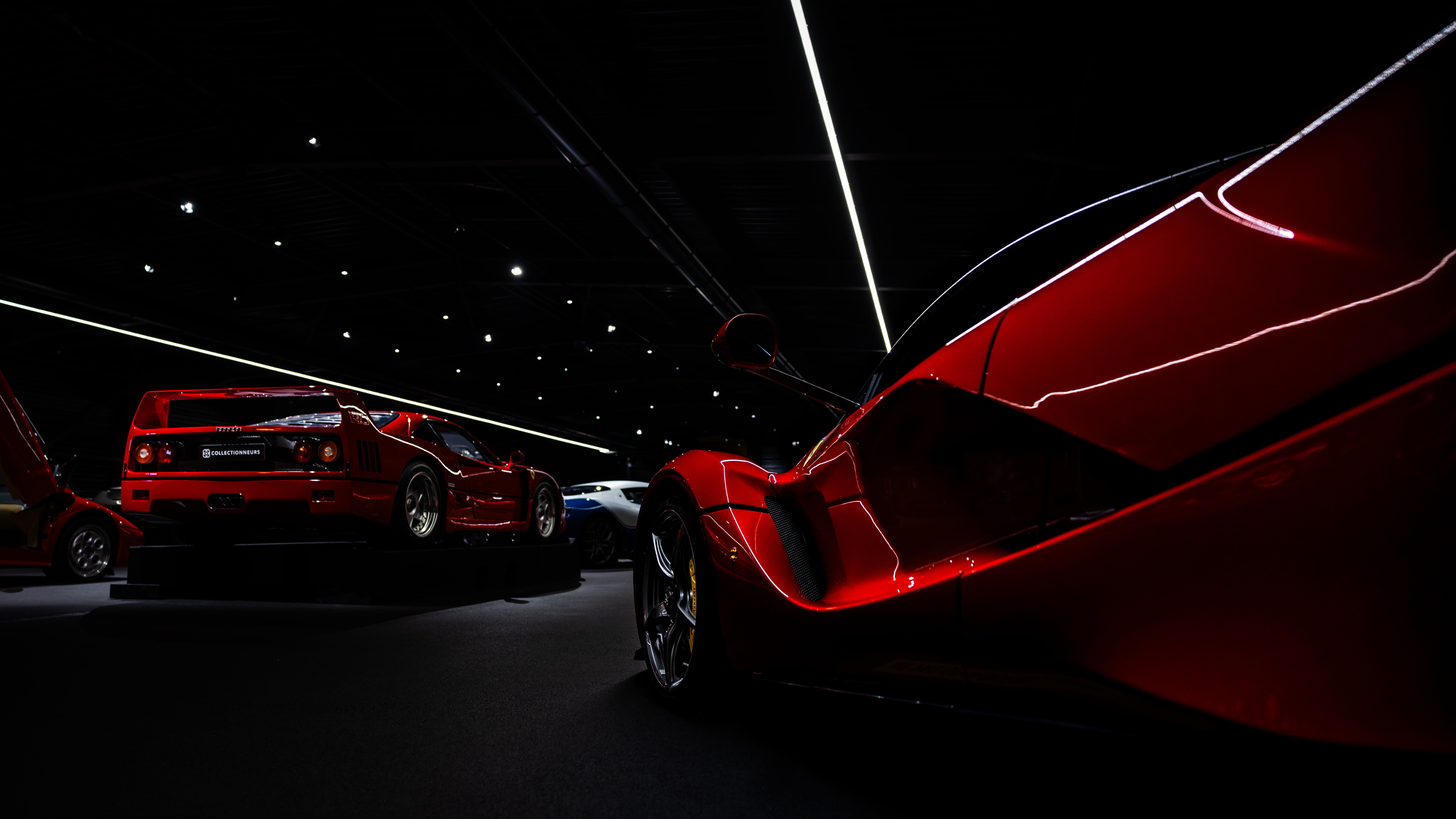 Sleek Red Sports Car Display in Dim Lighting · Free Stock Photo